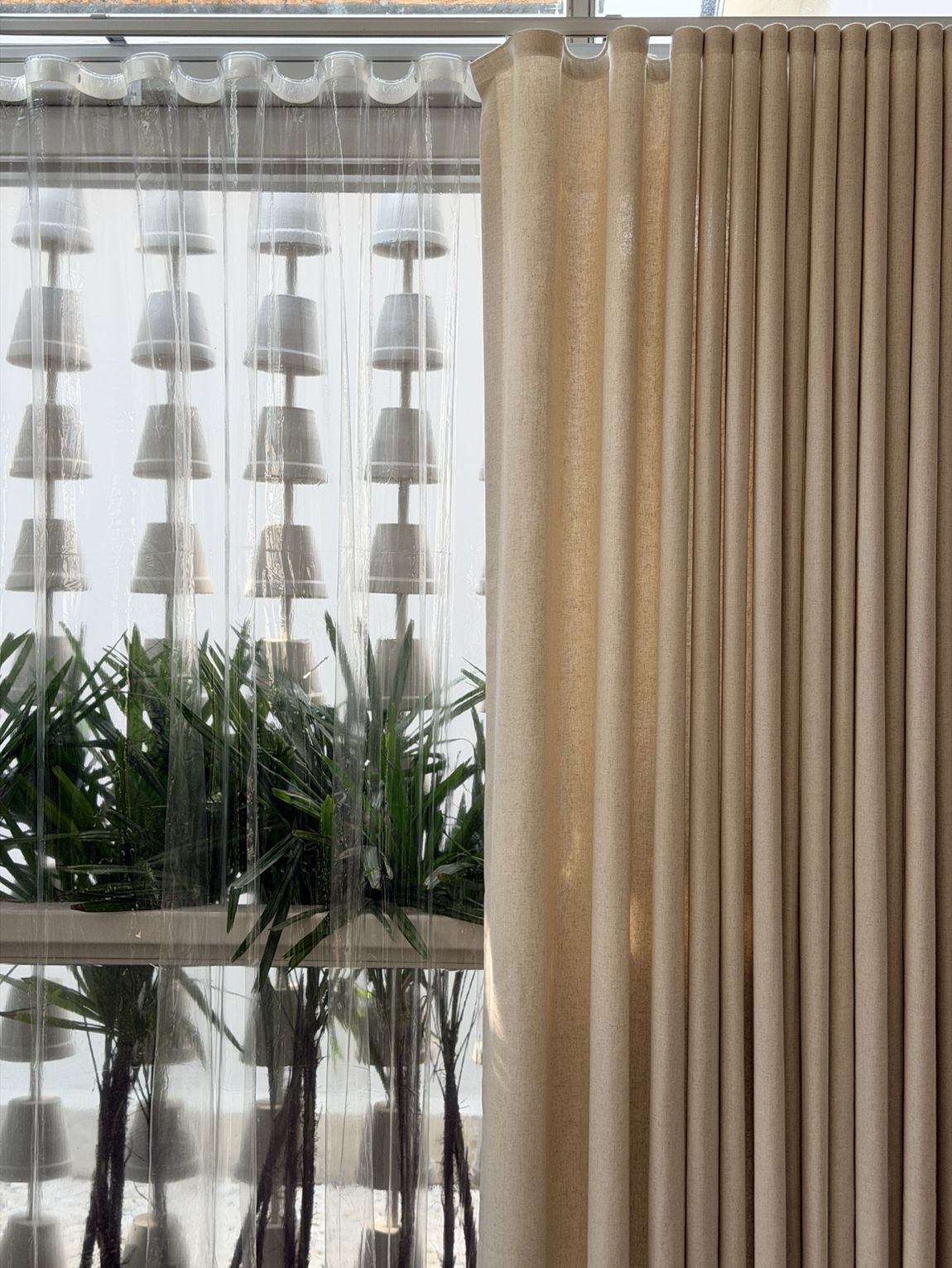 Living Space — Dimout and sheer at a planted window